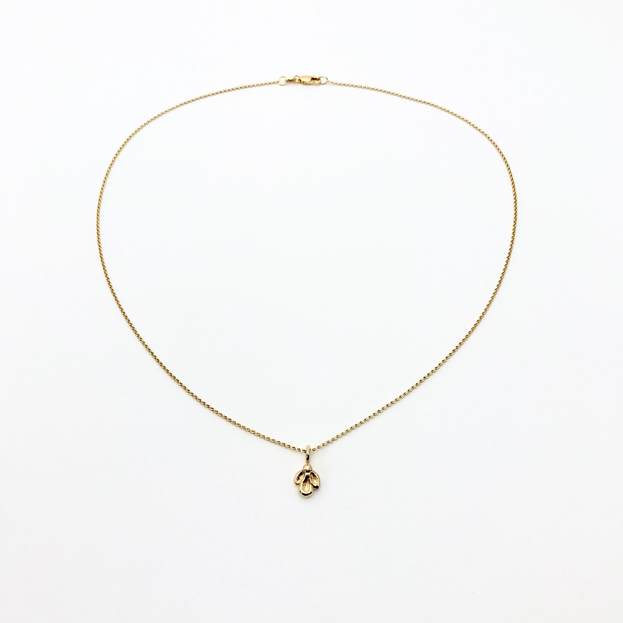 Gold necklace with small charm