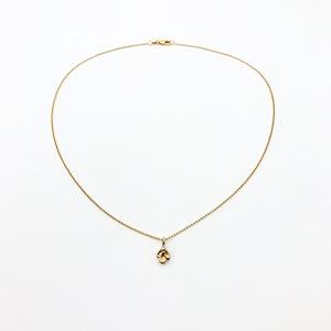 Gold necklace with small charm