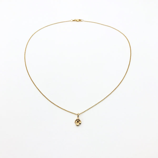 Gold necklace with small charm