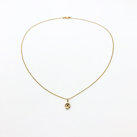 Gold necklace with small charm