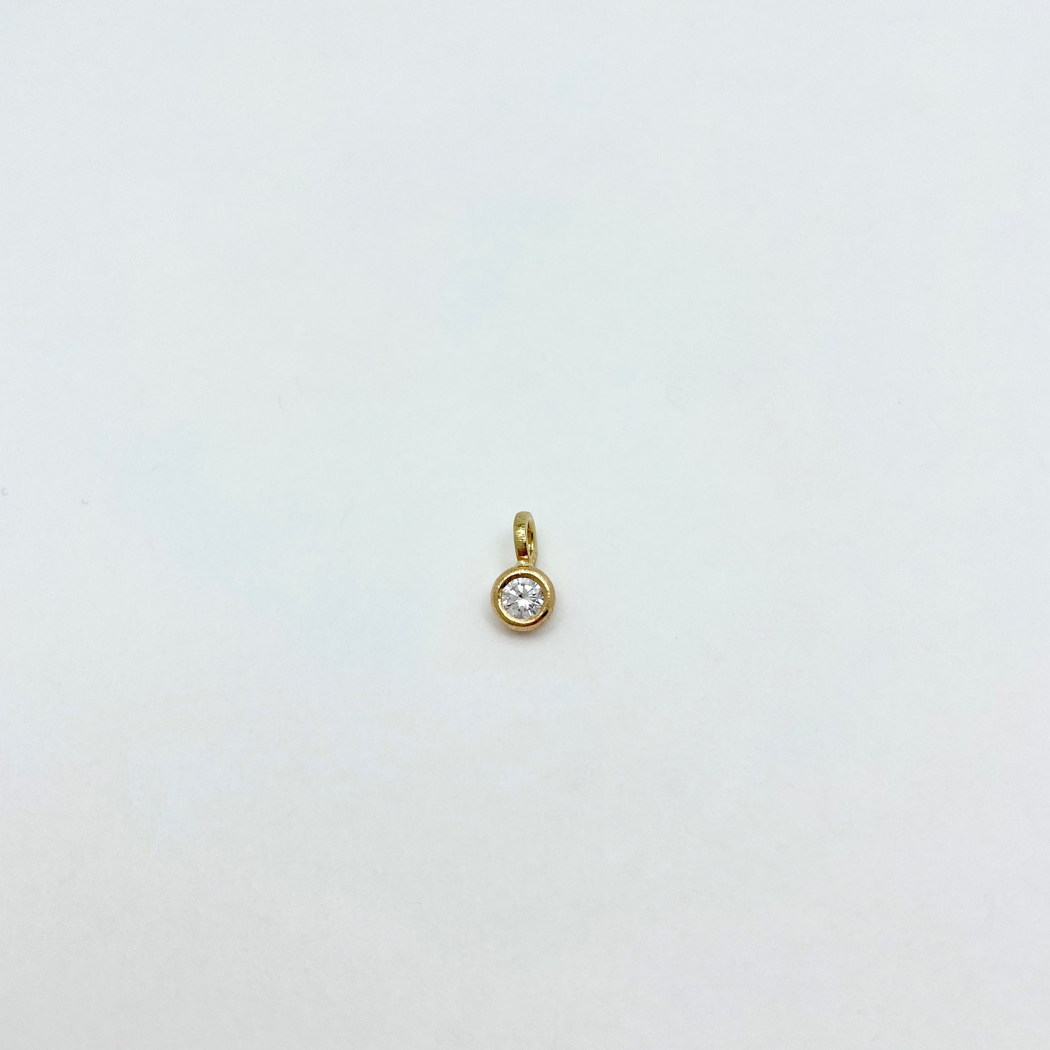 Gold charm with diamond