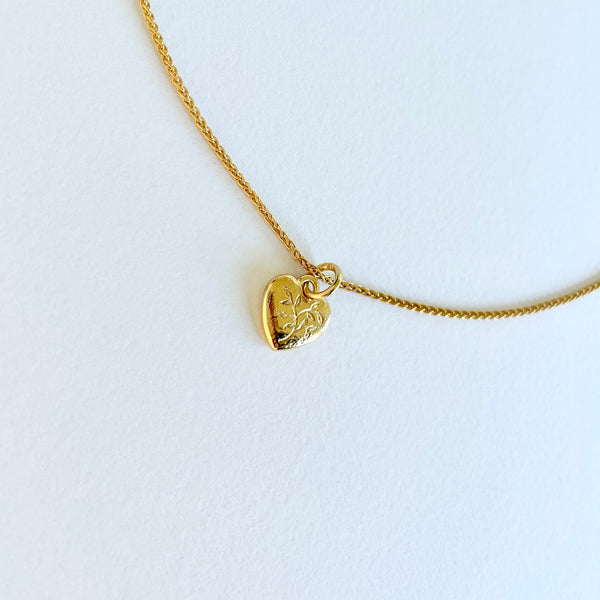 Gold necklace with engraved heart