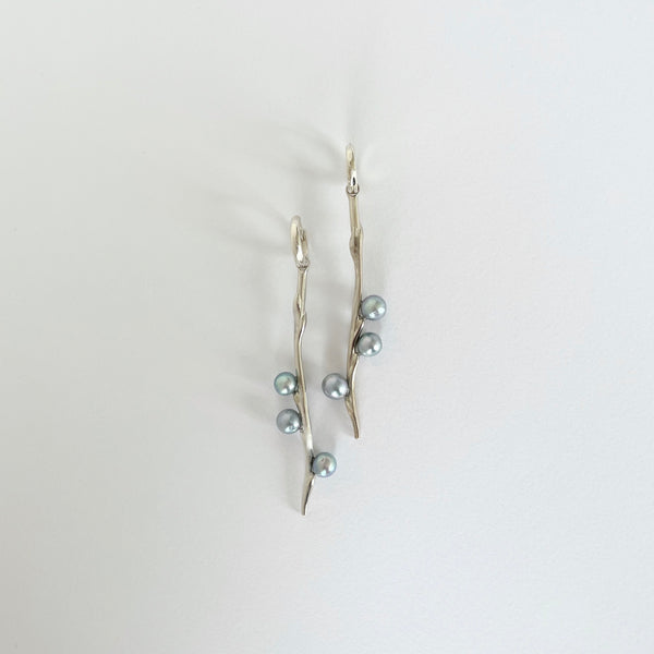 Long silver earrings with blueish pearls