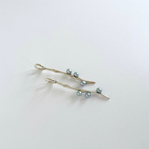 Long silver earrings with blueish pearls