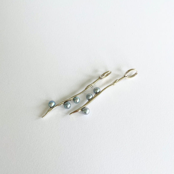 Long silver earrings with blueish pearls