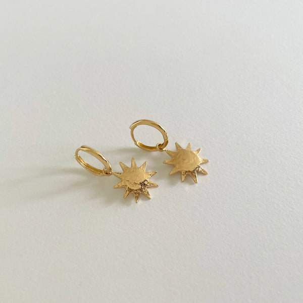 Gold earrings with sun