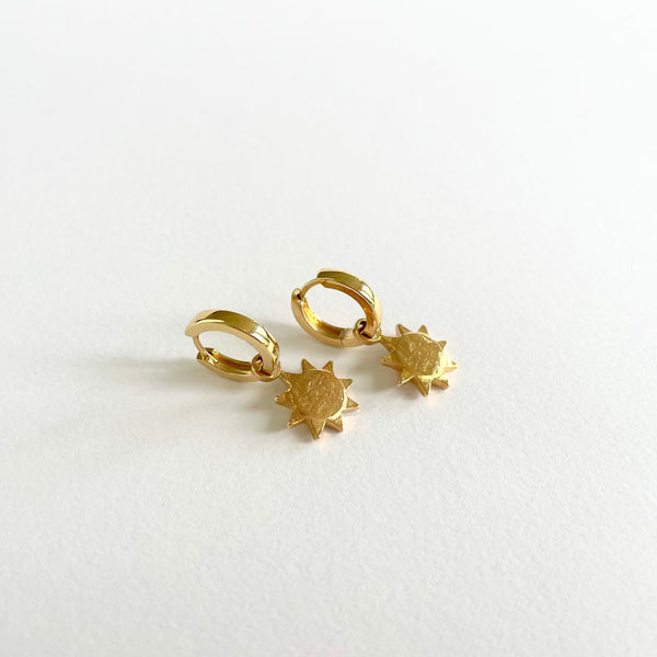 Gold earrings with small sun