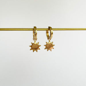 Gold earrings with small sun