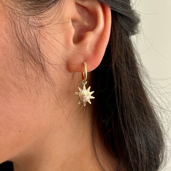 Gold earrings with sun