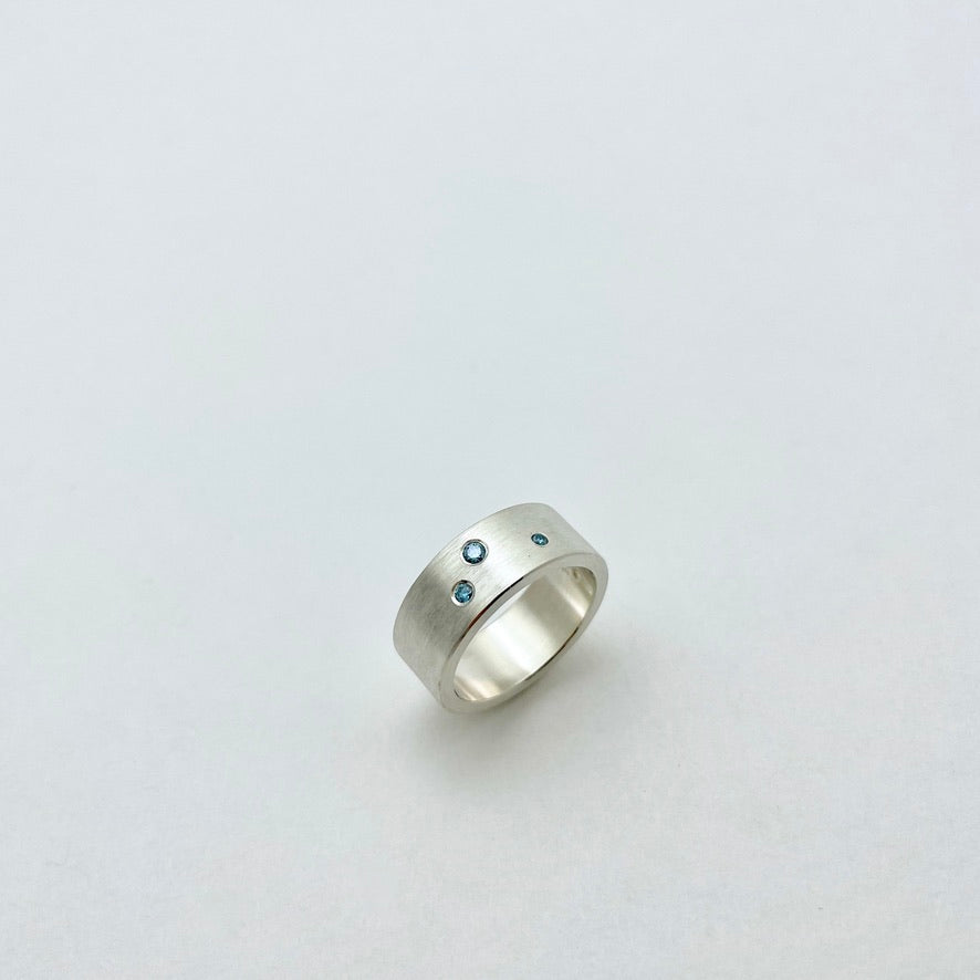 Silver ring with blue diamonds