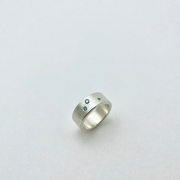 Silver ring with blue diamonds