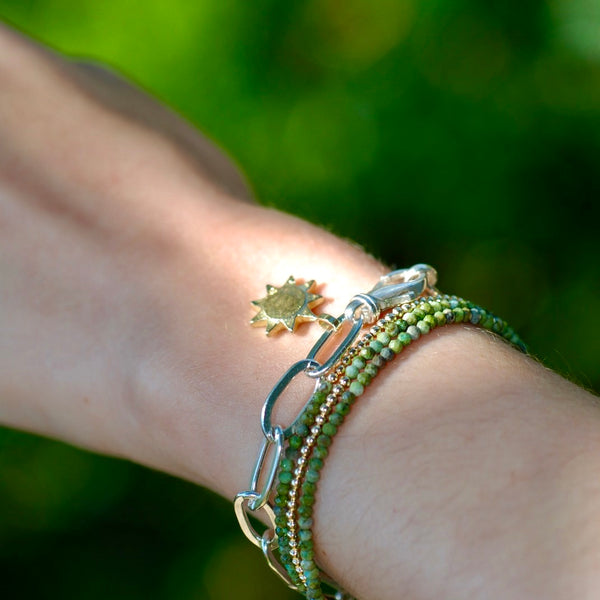 Silver bracelet with gold sun