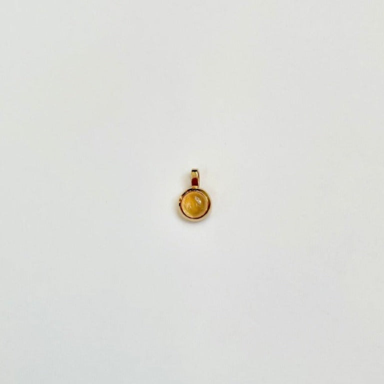 Gold charm with citrine