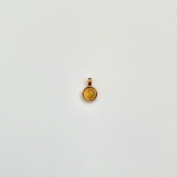 Gold charm with citrine