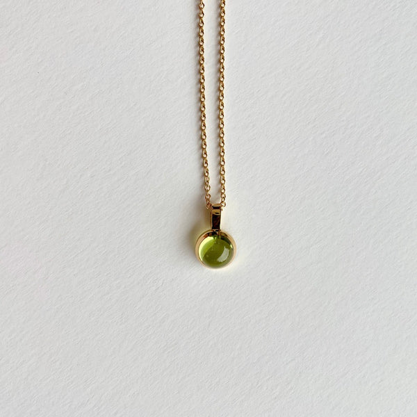 Gold charm with peridot