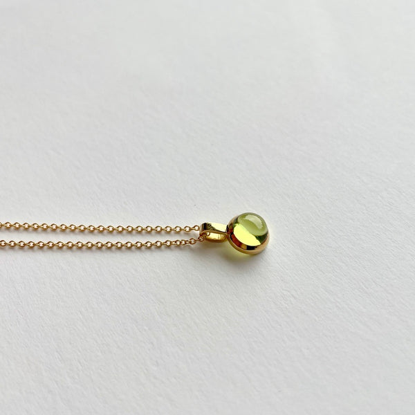 Gold charm with peridot