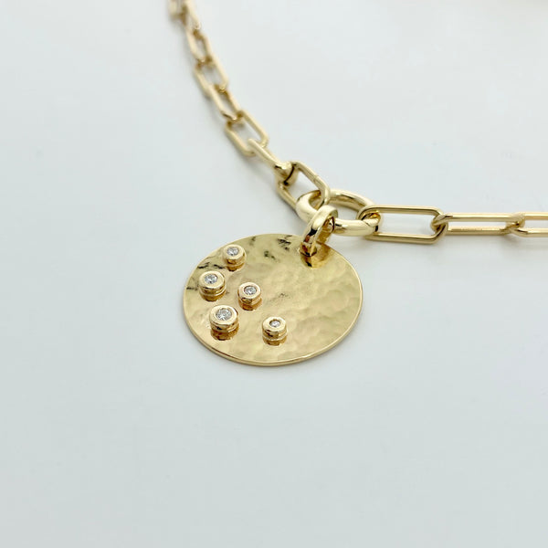 Gold necklace with hammered disk and 5 diamonds