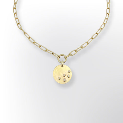 Gold necklace with hammered disk and 5 diamonds