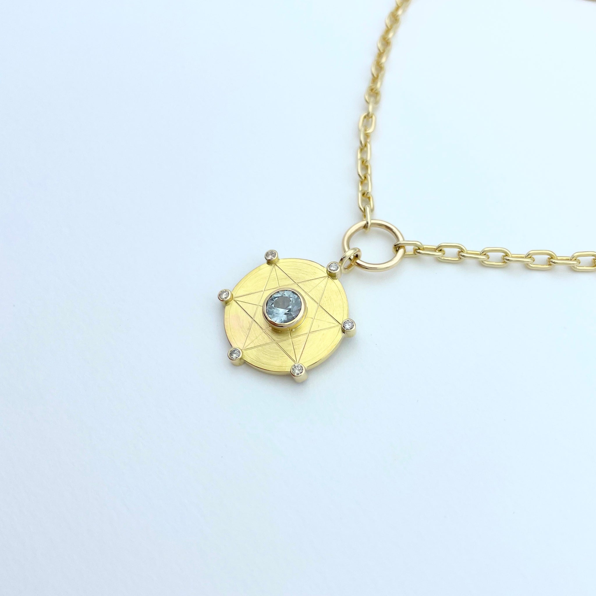 Gold necklace with light blue sapphire and diamonds