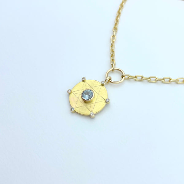 Gold necklace with light blue sapphire and diamonds