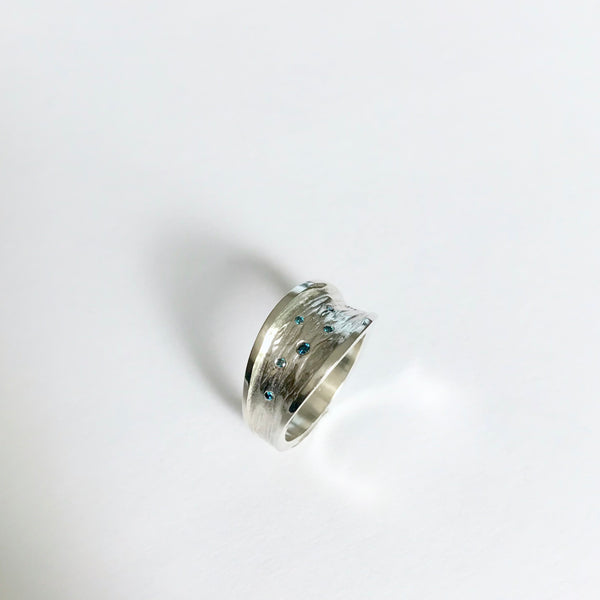 Silver ring with teal blue diamonds